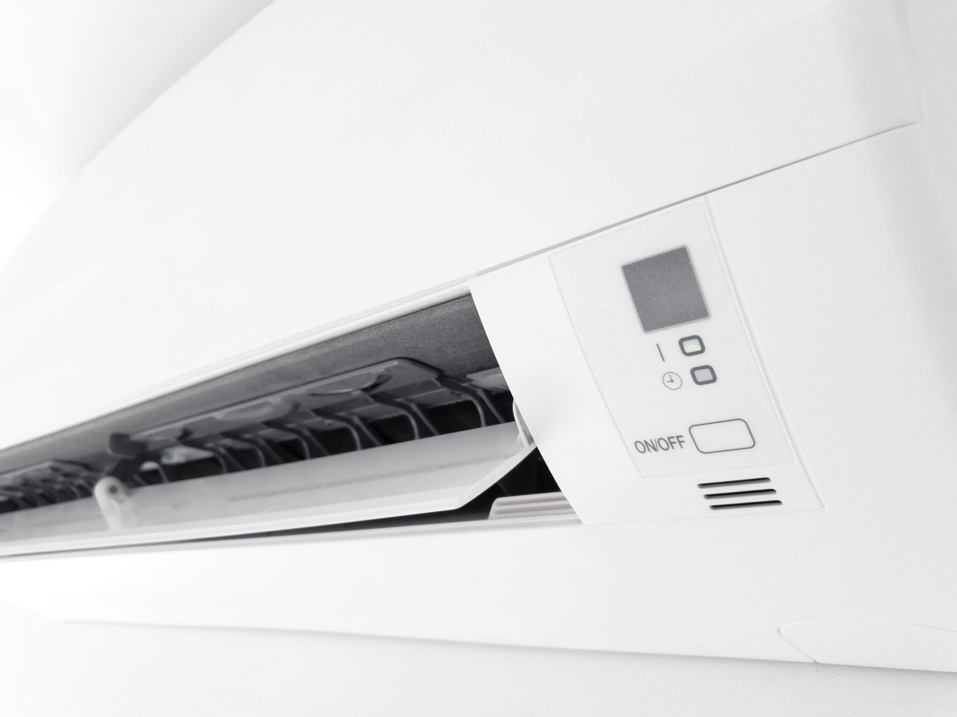 Modern heat pump indoor unit mounted on a clean white wall