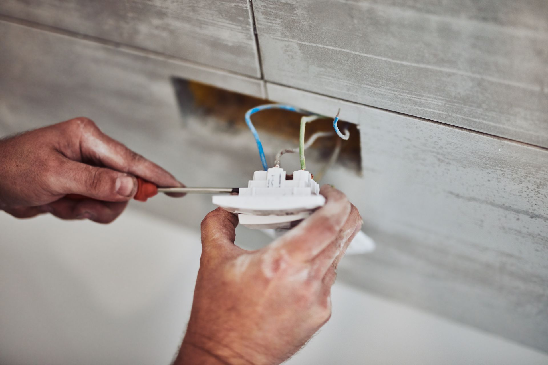 Technician installing a heat pump indoor unit